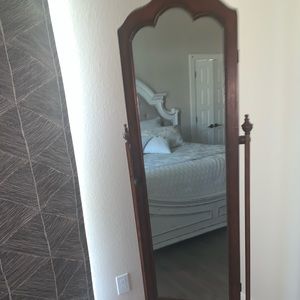 A nice jewelry cabinet with a full mirror!